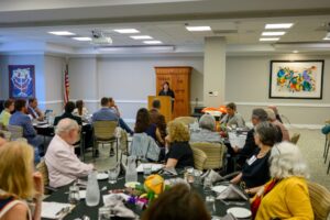 Annual Meeting 2025, Room Photo with Donna Horowitz at Podium Annual Meeting 2025, Room Photo with Donna Horowitz at Podium
