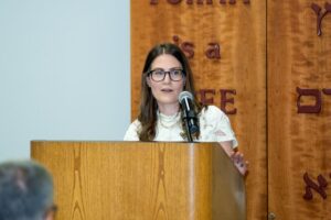 Annual Meeting 2025, Sarah Warren at Podium Annual Meeting 2025, Sarah Warren at Podium